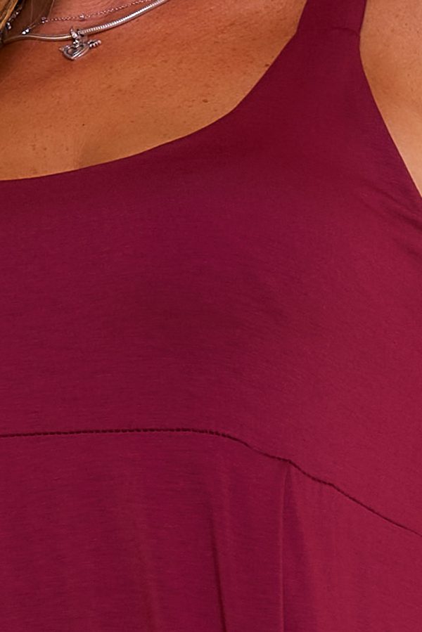Mono de tejido elástico con tirante ancho. Trae escote redondo y pantalón estilo bombacho con elástico en los tobillos.