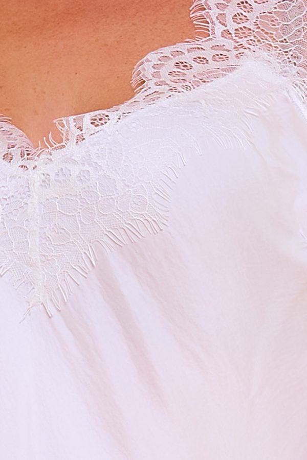 Una lencera elástica que tiene escote en pico. Tejido extremadamente suave y ligero. Tiene decoraciones en los bordes.