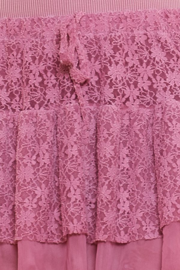 Una falda pantalón elástica con volantes de tul con diseño diseño primaveral. Tiene goma elástica en la cintura y cordones decorativos.