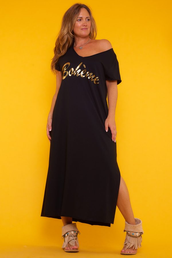 Un vestido largo elástico que tiene manga corta y un escote en pico amplio. Tiene un estampado en la parte frontal y dos aperturas laterales.