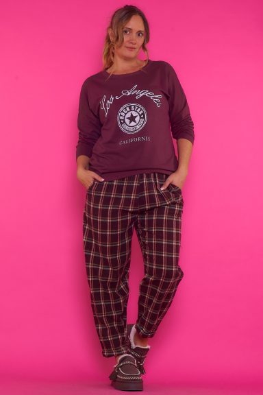 Pantalón Chándal Crosbi Un pantalón de estilo chándal que tiene un estampado de cuadros. Es de pierna recta, tiene bolsillos y una goma elástica en la cintura.